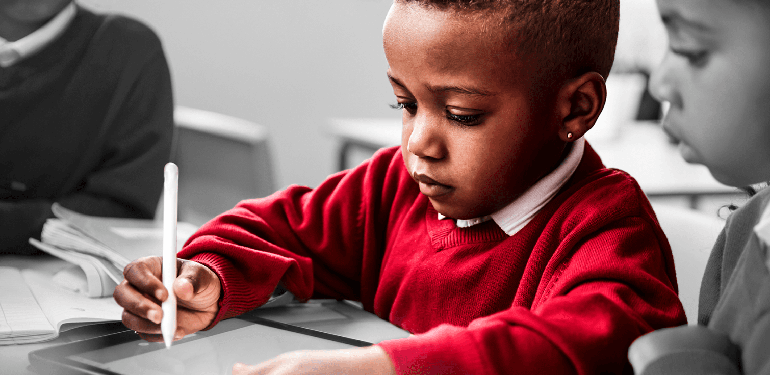 Young african american boy writing