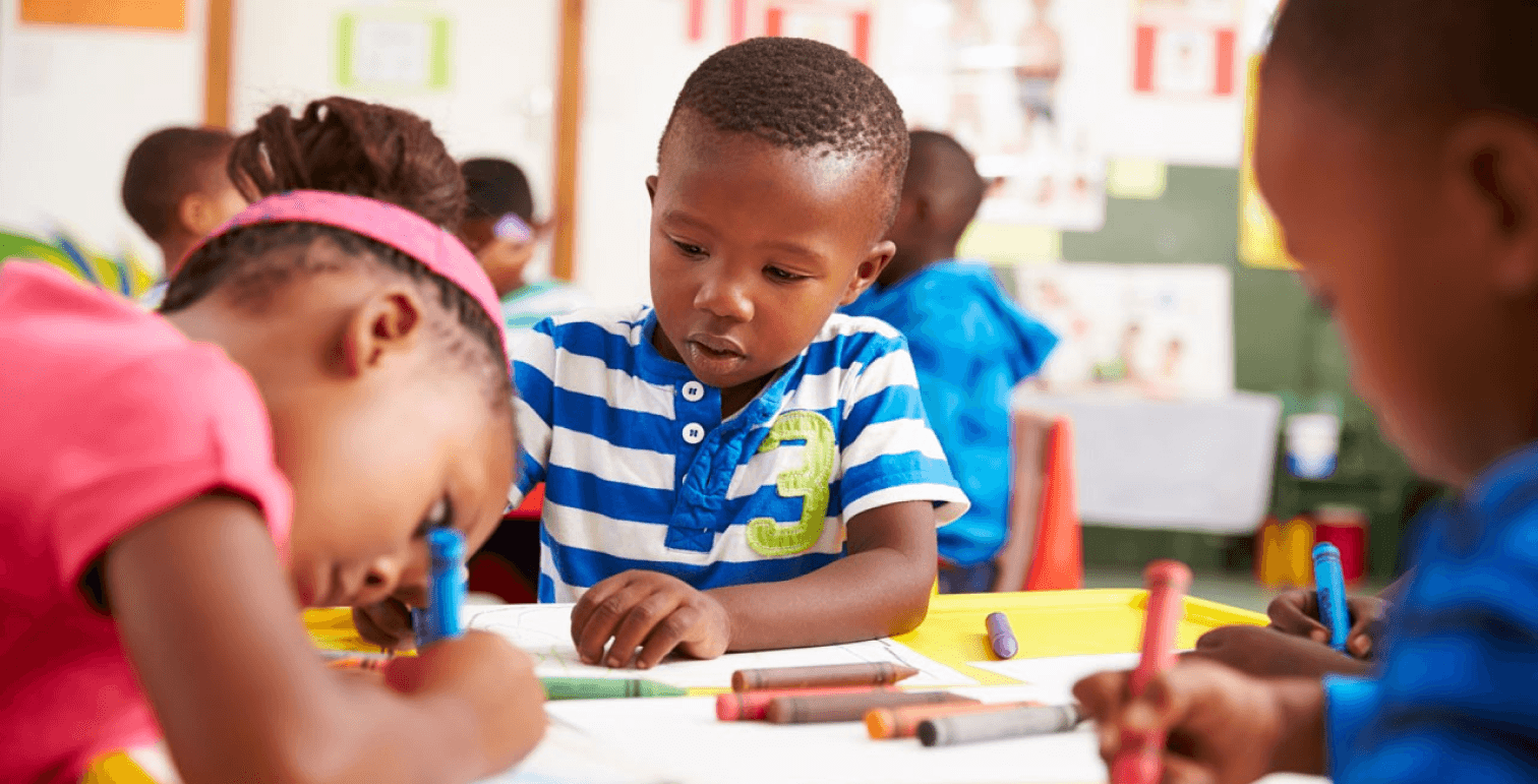 Young african american boy writing