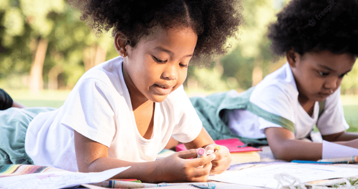 Young african american boy writing