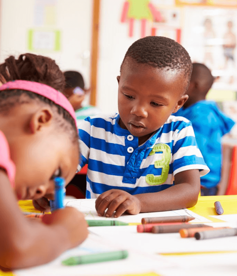 Young african american boy writing